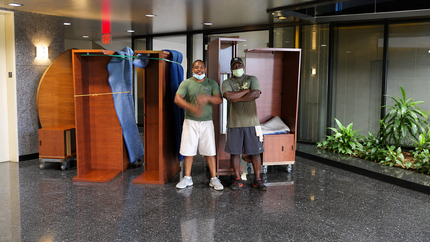 Commercial moving crew with office furniture in a lobby