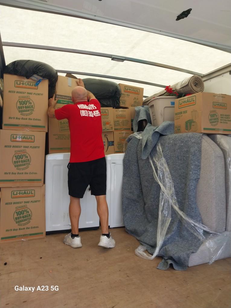 Mover loading boxes into a packed moving truck