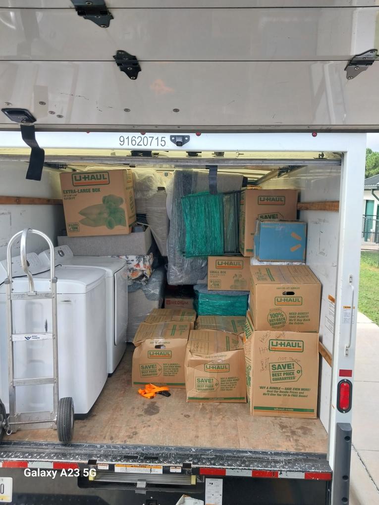 Box truck loaded with appliances, boxes, and protected furniture