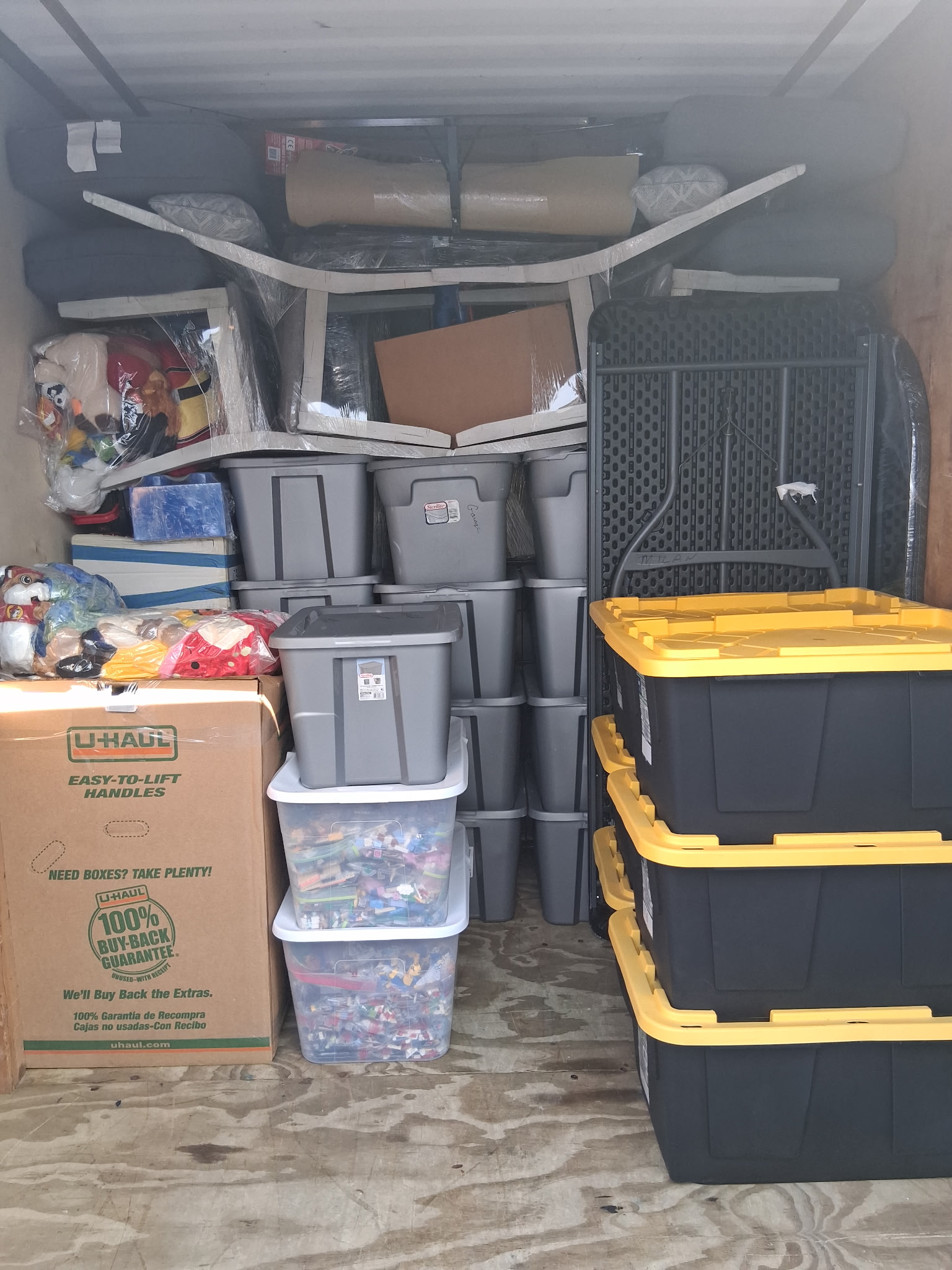 Packed moving truck with storage bins and household goods
