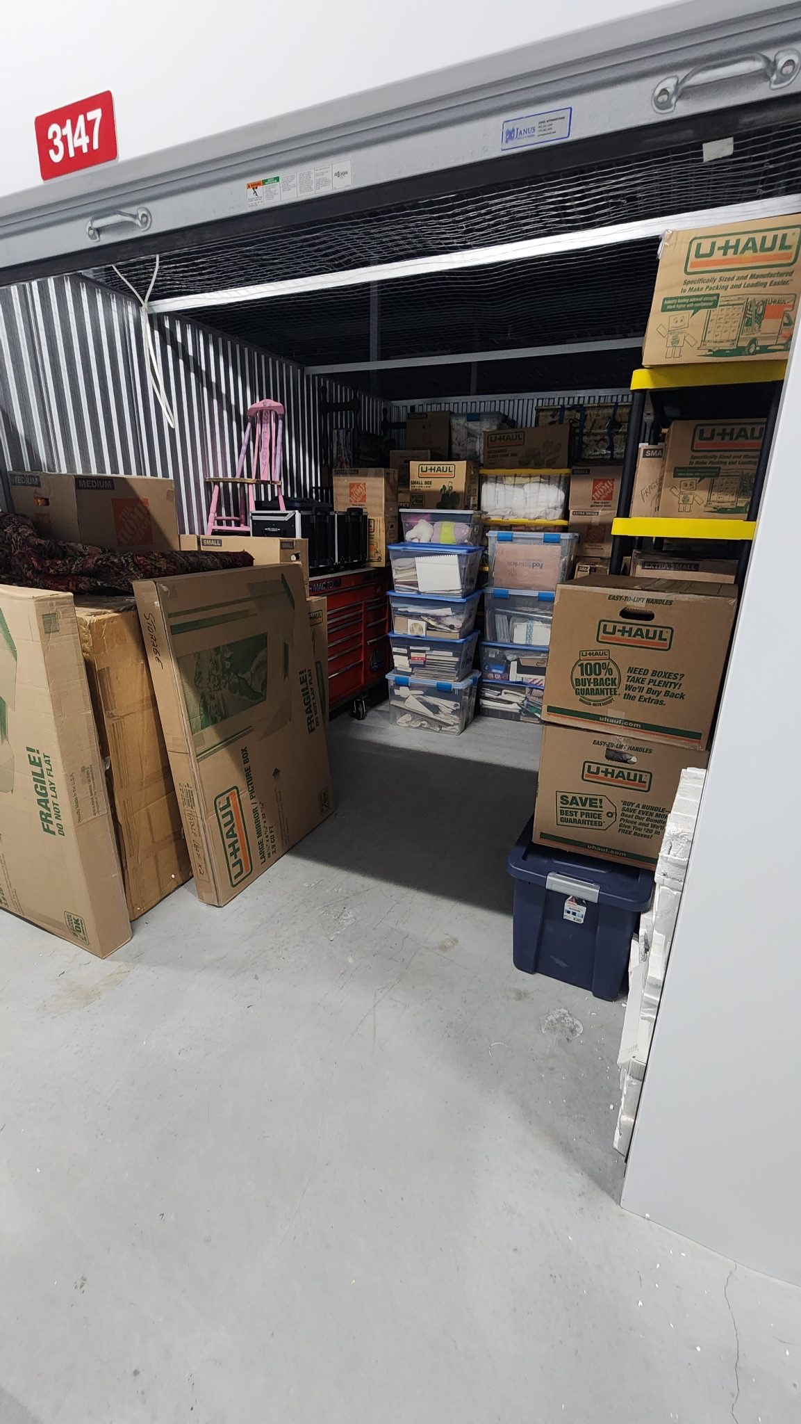 Storage unit packed with boxes, bins, and household items